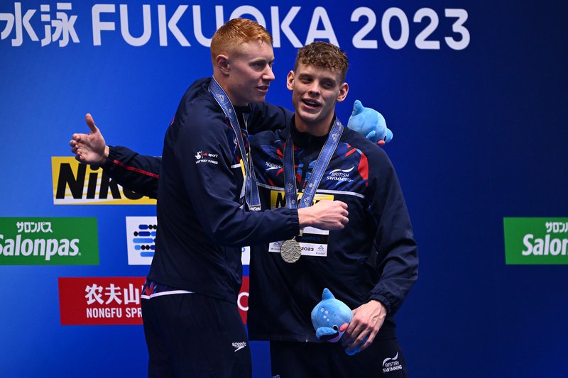 Tom Dean Matt Richards podium hug World Champs silver and gold 200m Free Fukuoka 2023
