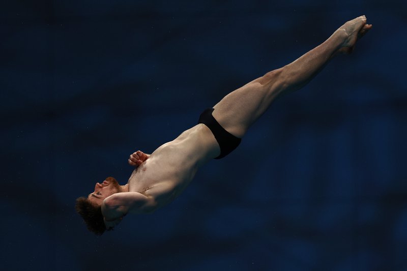 Matty Lee twist laying back pose 10m Platform Budapest 2022